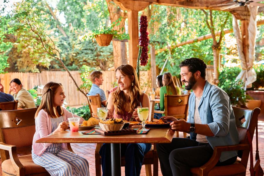A family of a mom, dad and young girl eat at El Pinto Restaurant